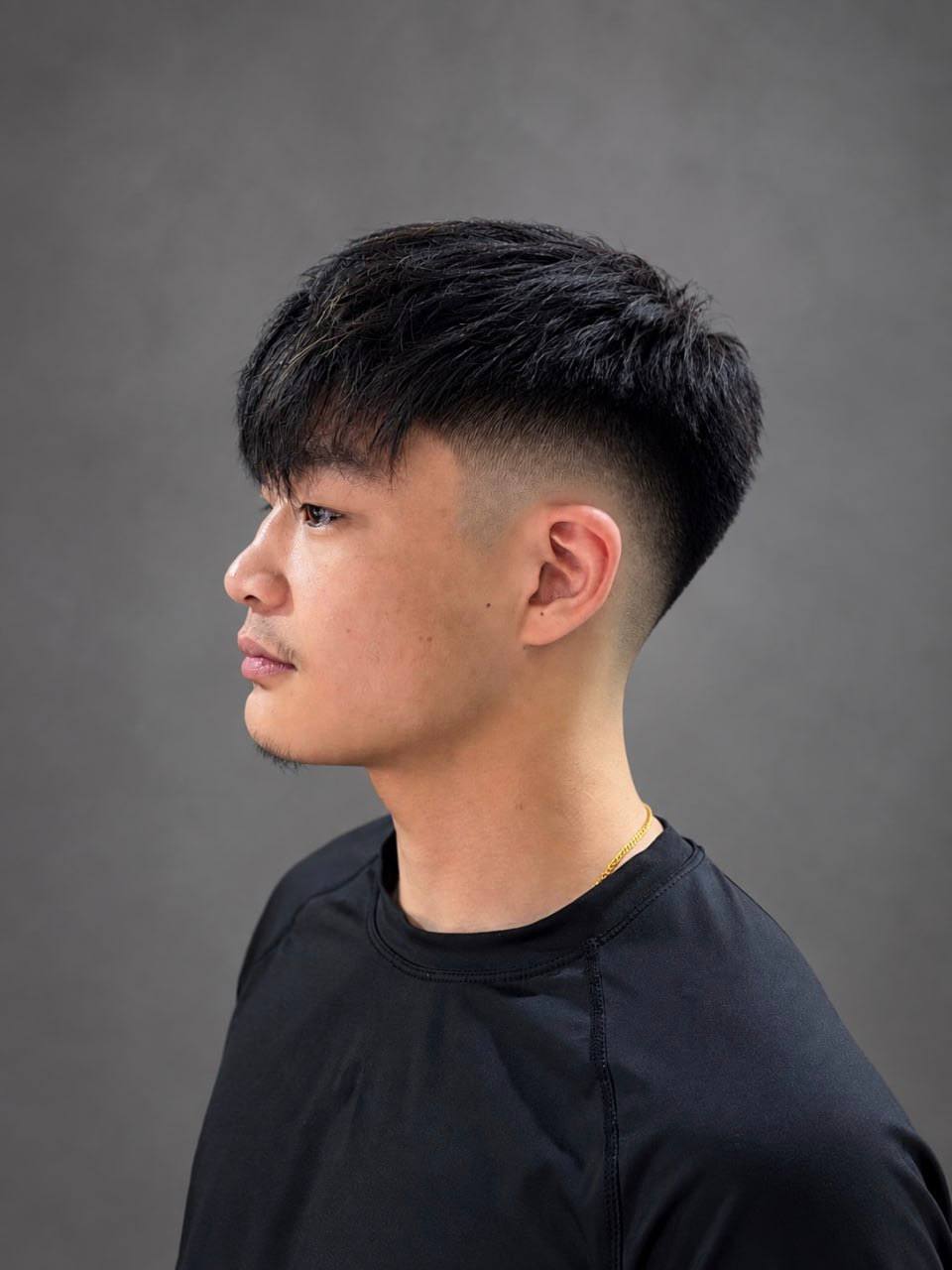 A short textured crop with a fade, cut at Crew Barbers
