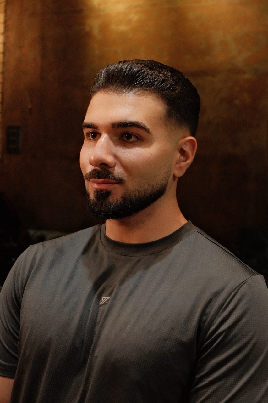 A neat slicked-back style, cut at Crew Barbers