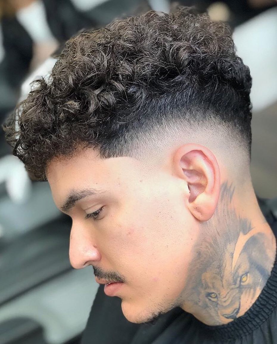 Natural curls over a clean mid fade