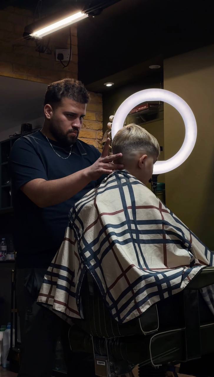 A Crew barber mid-cut inside the Isleworth shop