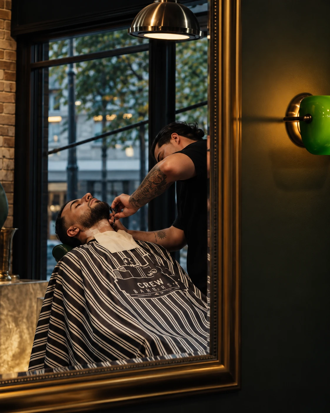 A Crew barber shaving a client's beard at Whitton